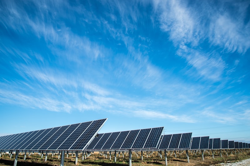 Solar energy technician servicing photovoltaic panels